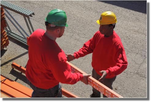 INI workmen examining parts 1