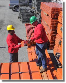 INI workmen examining parts 2